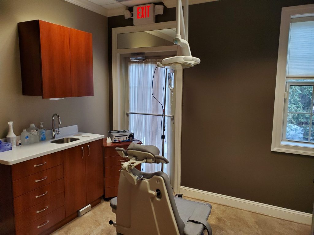 Dental chair in patient room at {PRACTICE_NAME}